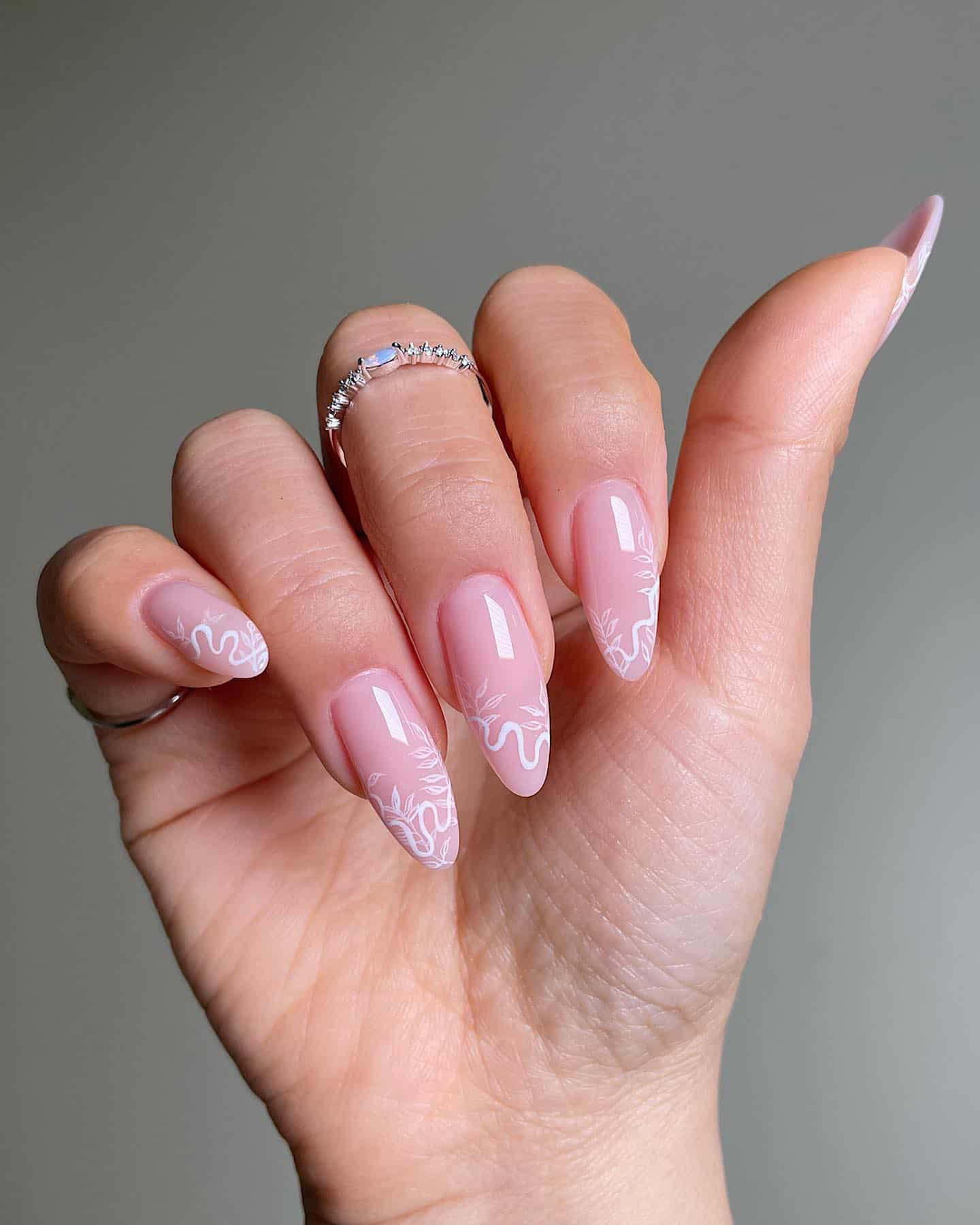 image of a hand with nude pink nails with white wave french tips