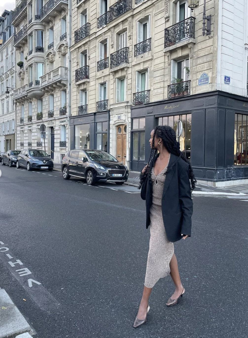 French woman wearing an oversized blazer with a dress and kitten heels in Paris
