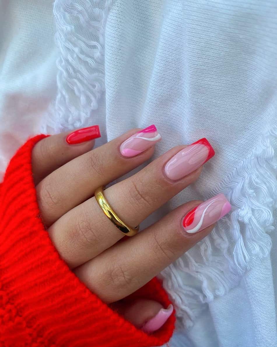 hand with long square nails with pink and red wavy designs