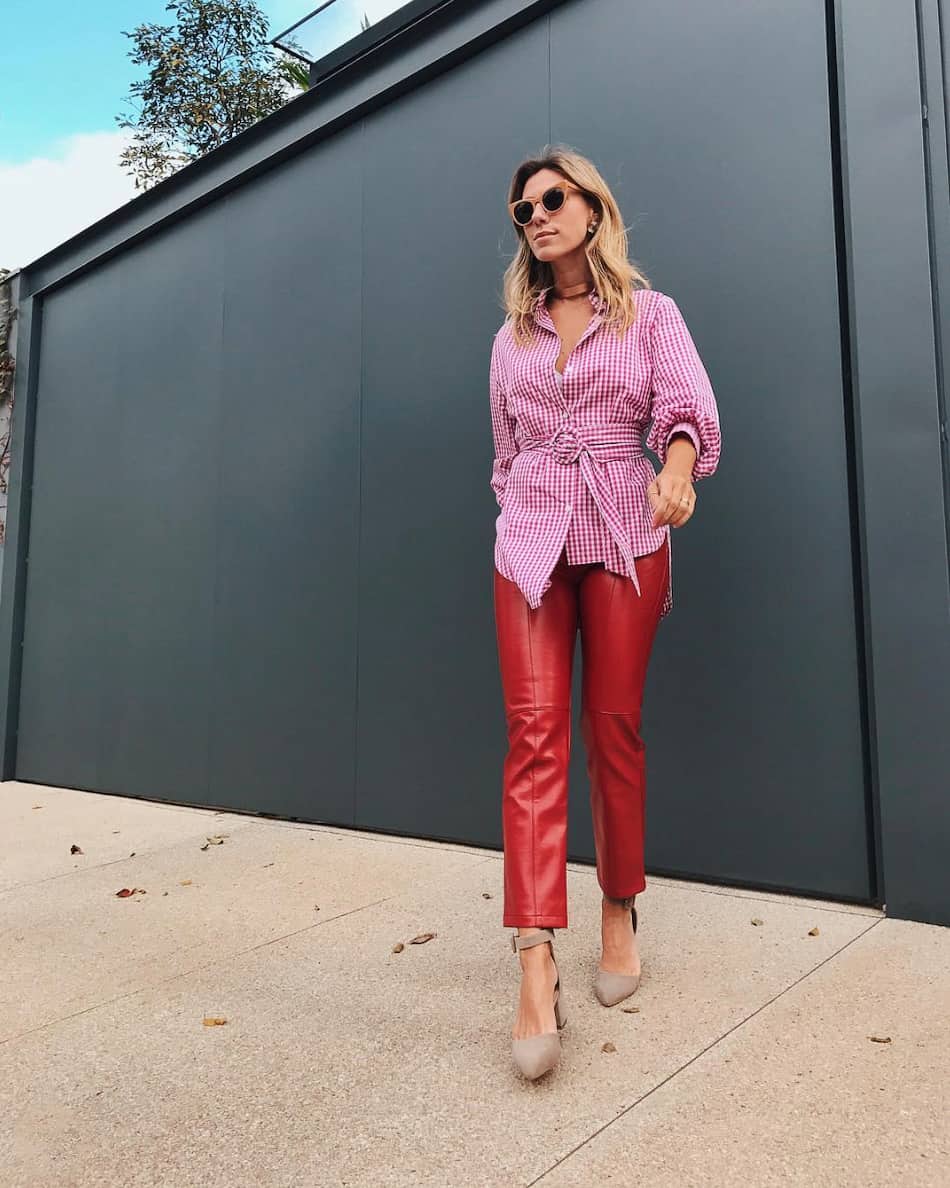 woman wearing a pink checkered top with red leather pants and nude heels