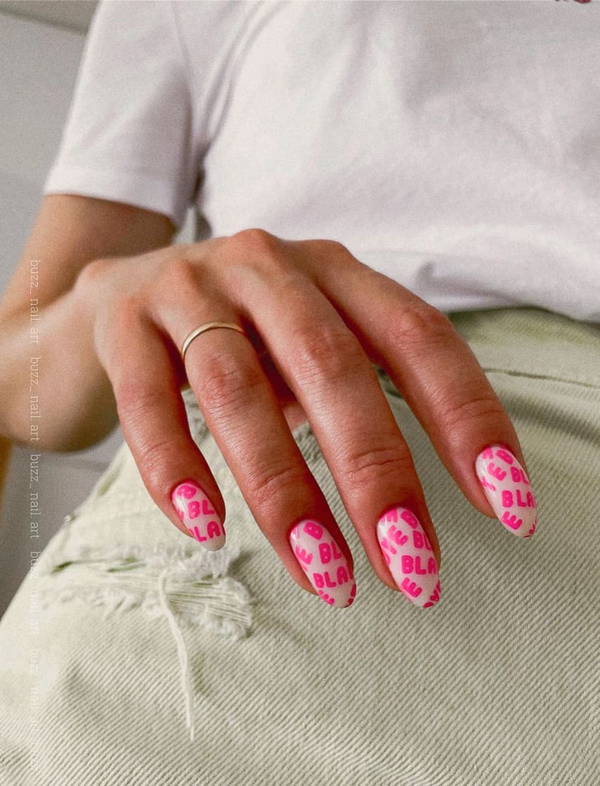 image of a hand with white nails with hot pink text