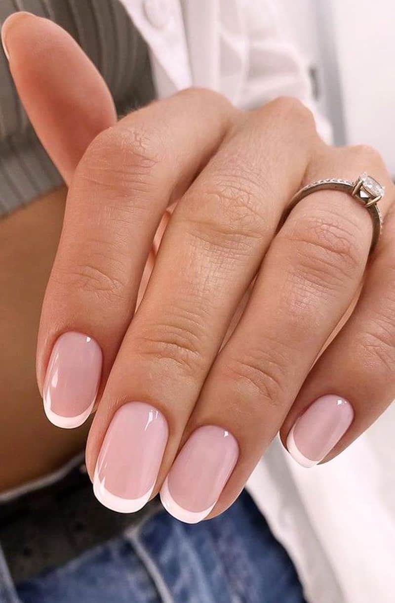 image of a hand with a classic pink and white french tip manicure