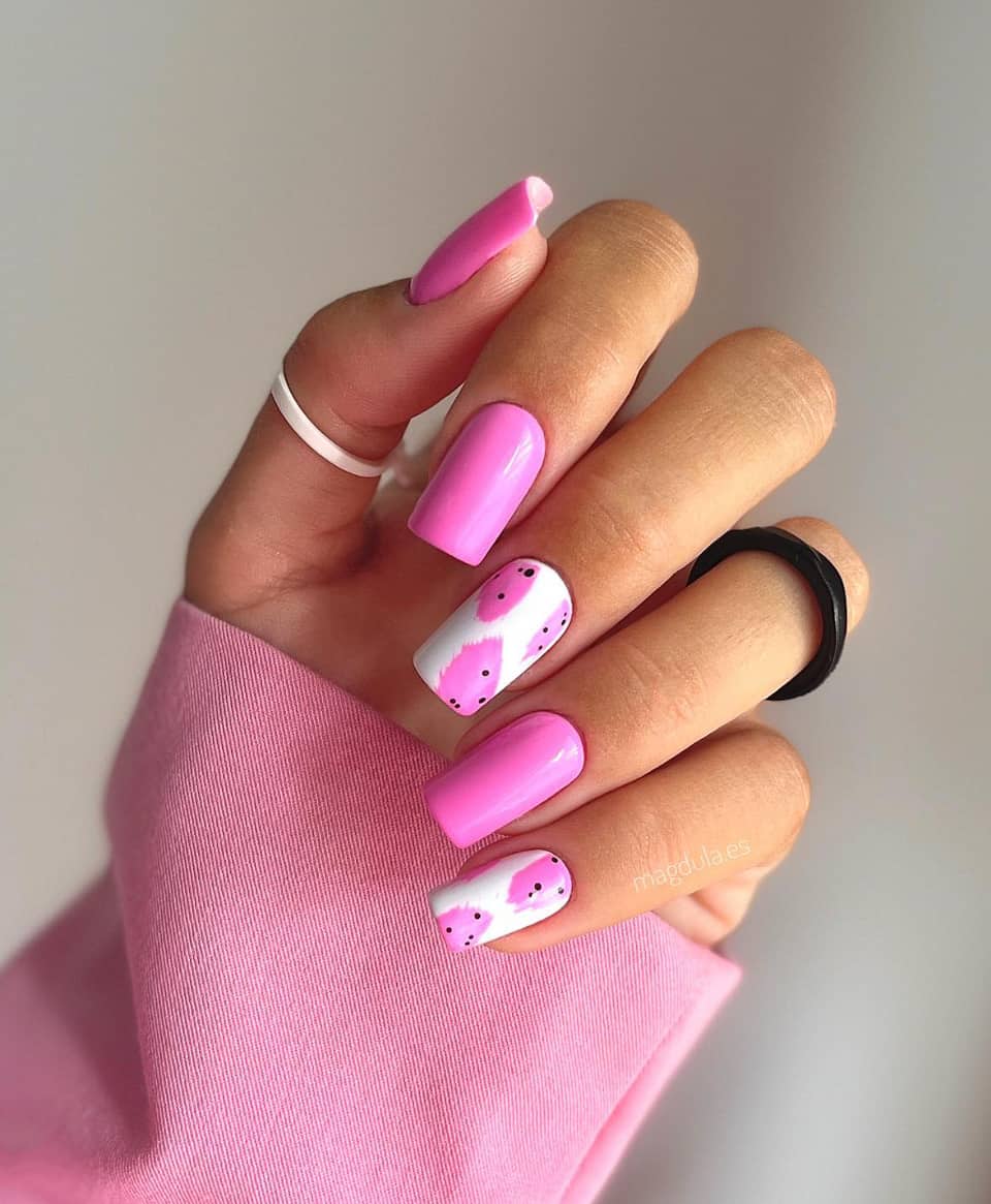 image of a hand with hot pink and white nails with pink splash accents