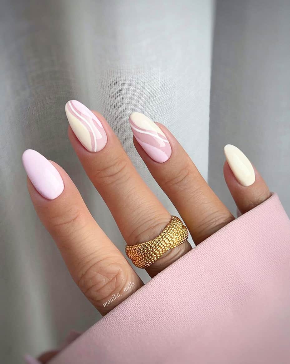 image of a hand with white nails with light pink wave accents