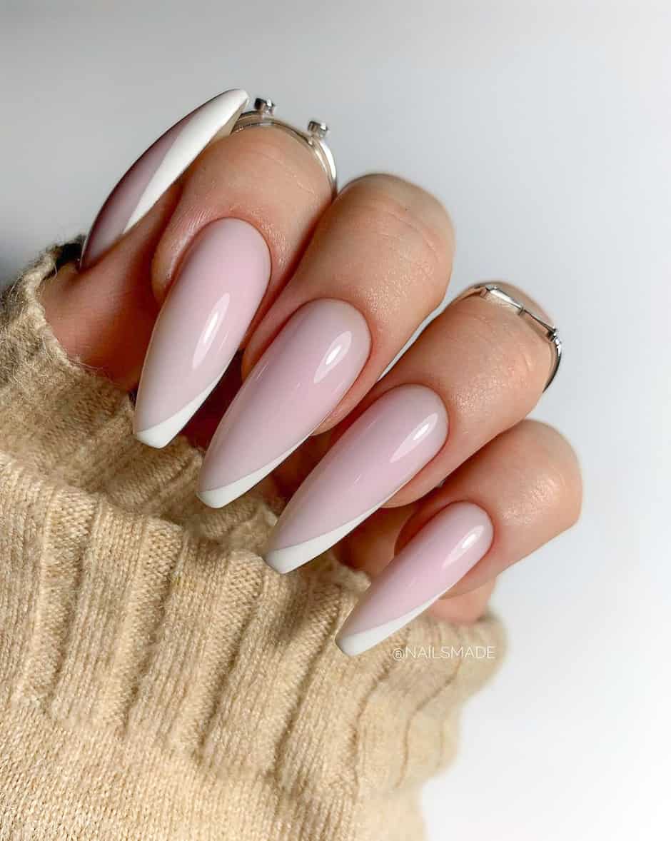 image of a hand with long acrylic nails with a pink and white french tip manicure