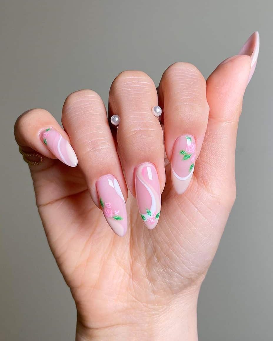 image of a hand with ombre pink and white nails with floral art