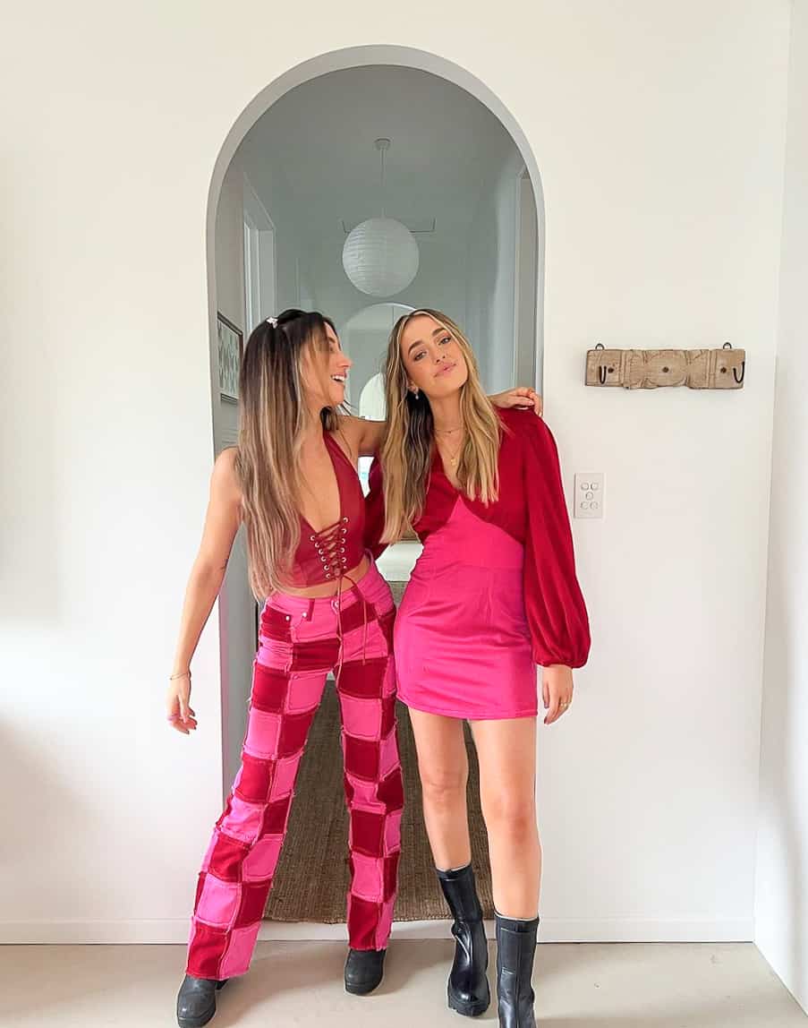two young women wearing hot pink and red 90s style outfits