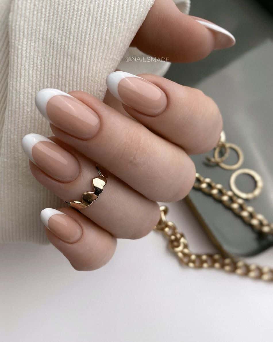 an image of a hand with a French manicure with a beige nail polish