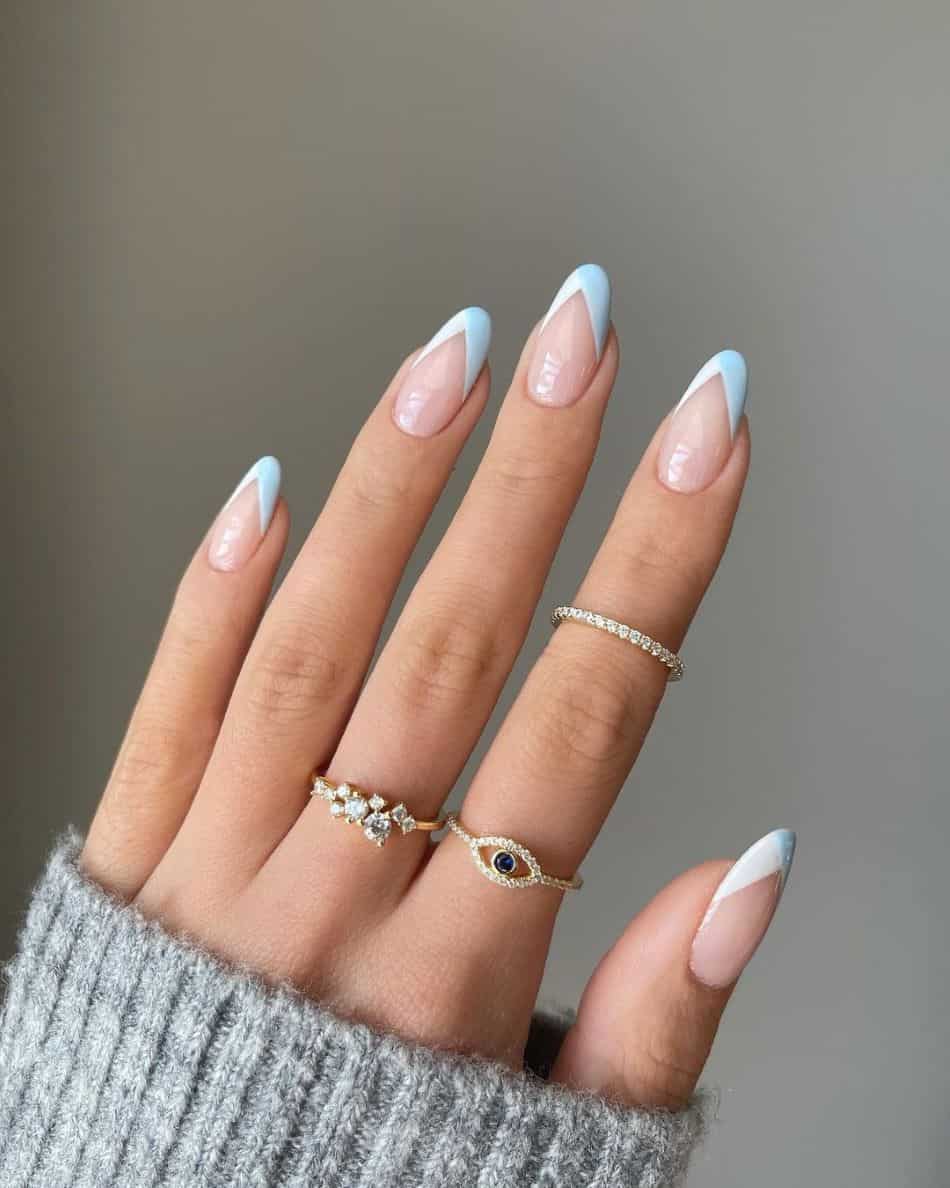 Almond nails with white and light blue French tips. 