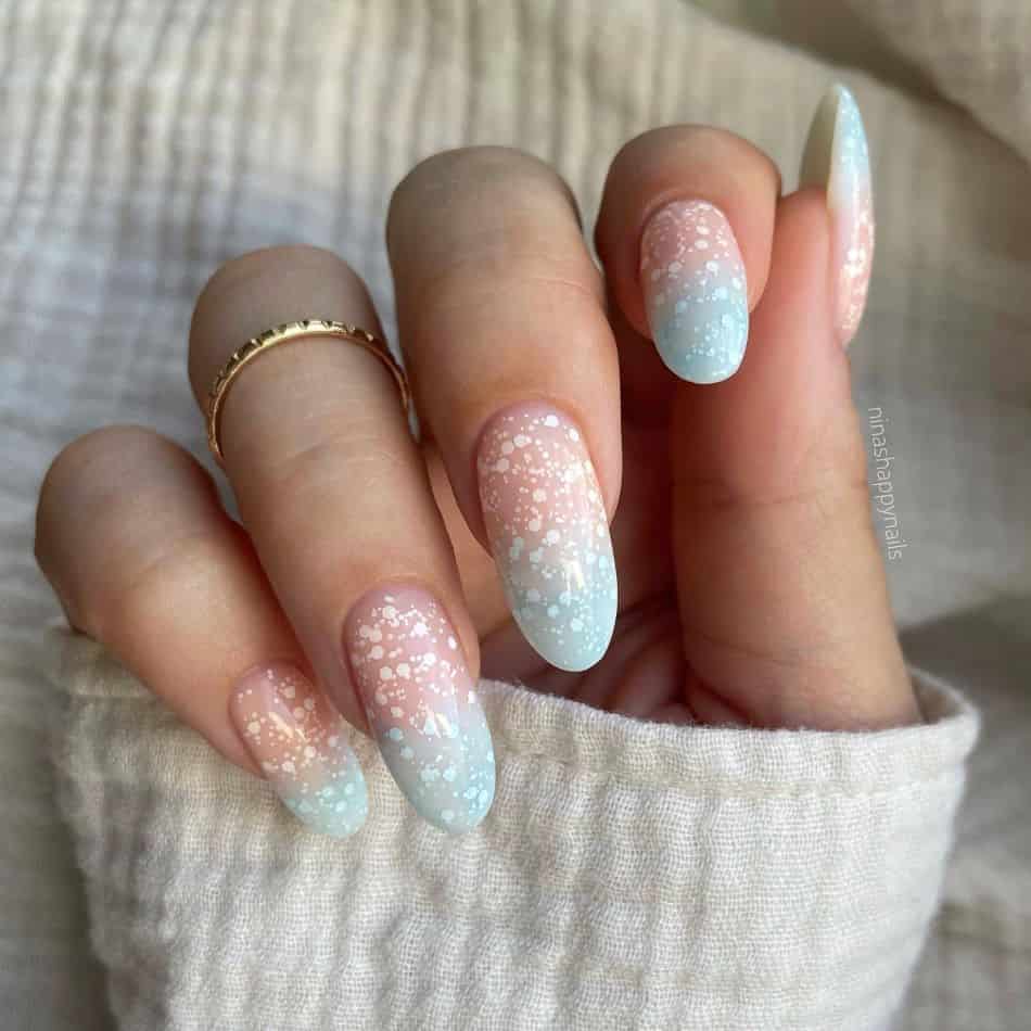 Almond nails with icy blue ombre and white glitter. 