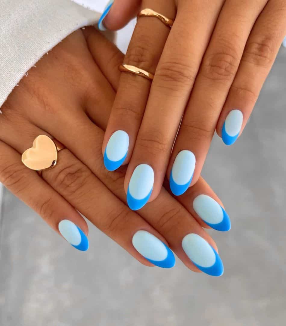 Soft blue almond nails with royal blue French tips.