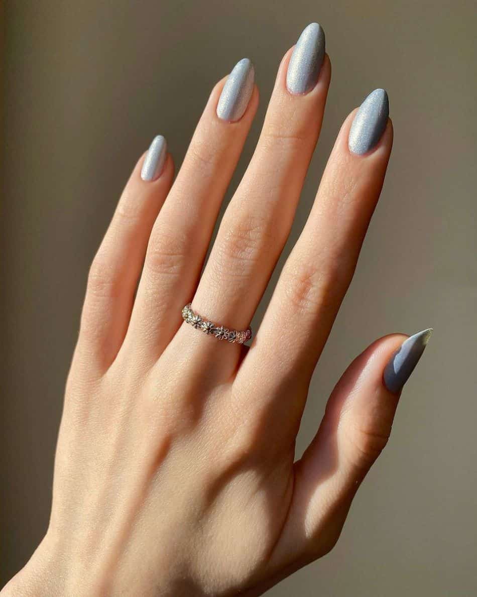 Almond nails with shimmering pastel blue polish. 