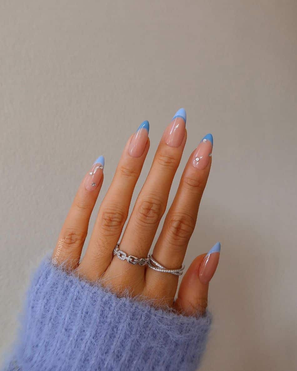 Baby blue French manicure with gem accents. 