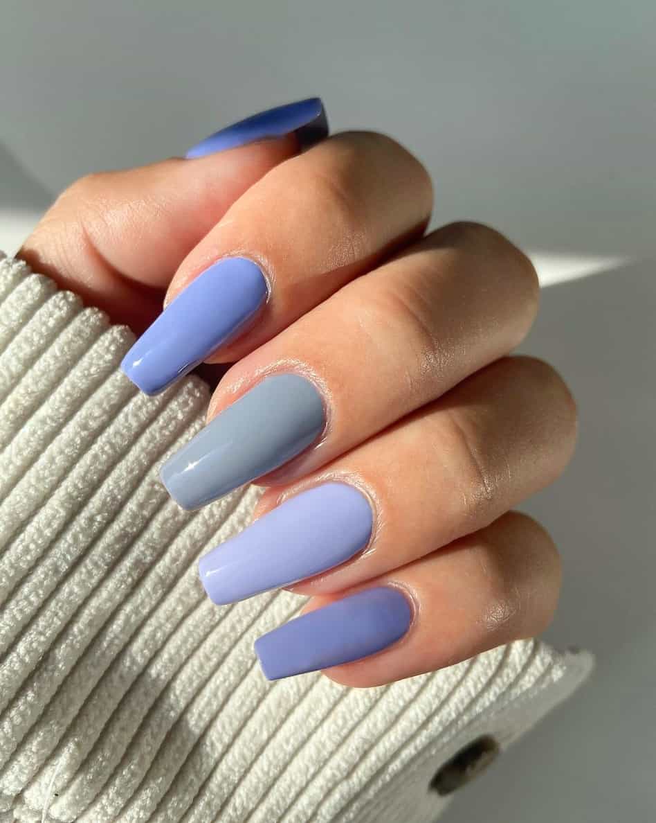 A hand with gradient periwinkle on long square nails