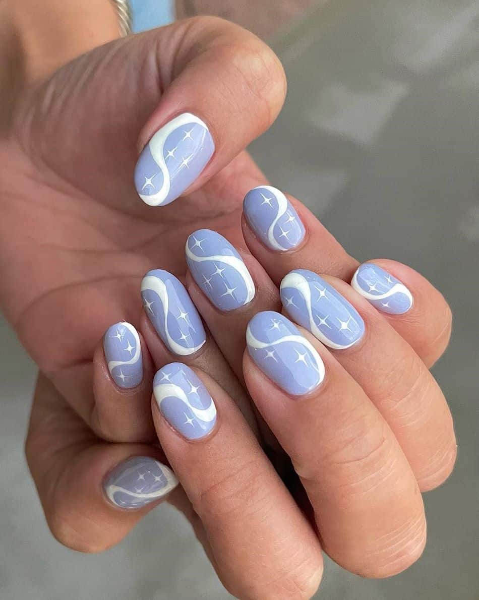 A hand with periwinkle polish and white sparkled and waves