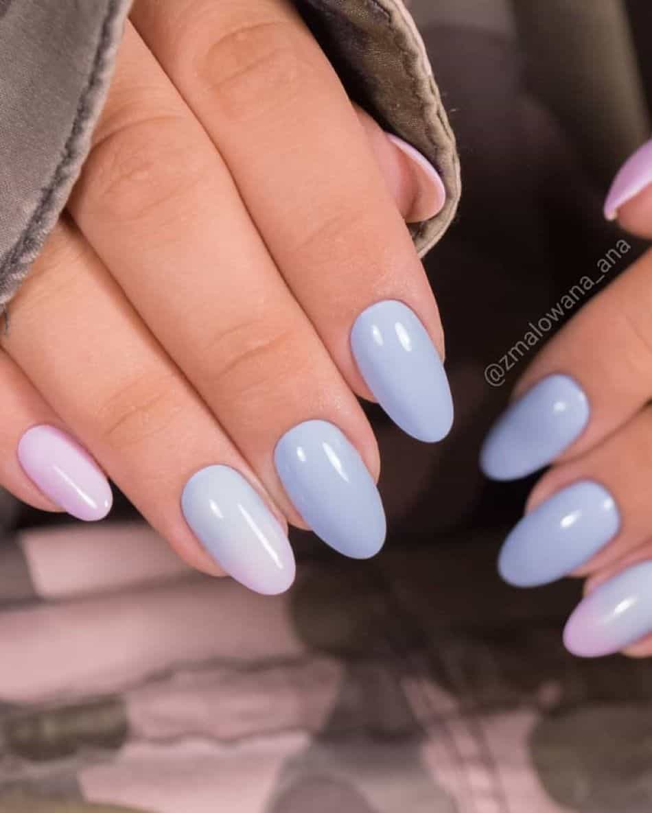 A hand with solid periwinkle nails with pink accent nails