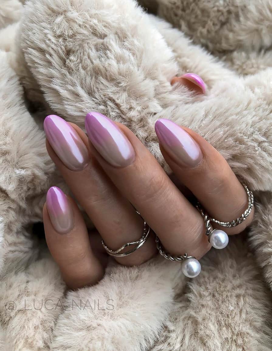 An image of a hand with metallic purple and white ombre nails