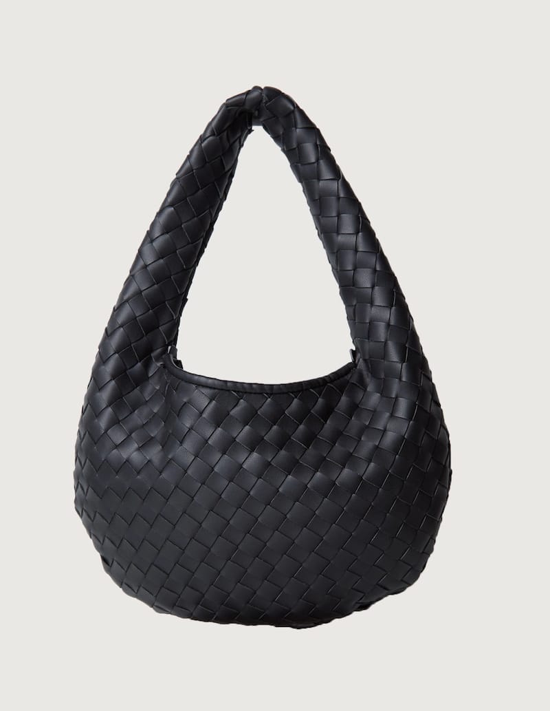 a black woven hobo bag that's a look allike of the Bottega Veneta Jodie bag