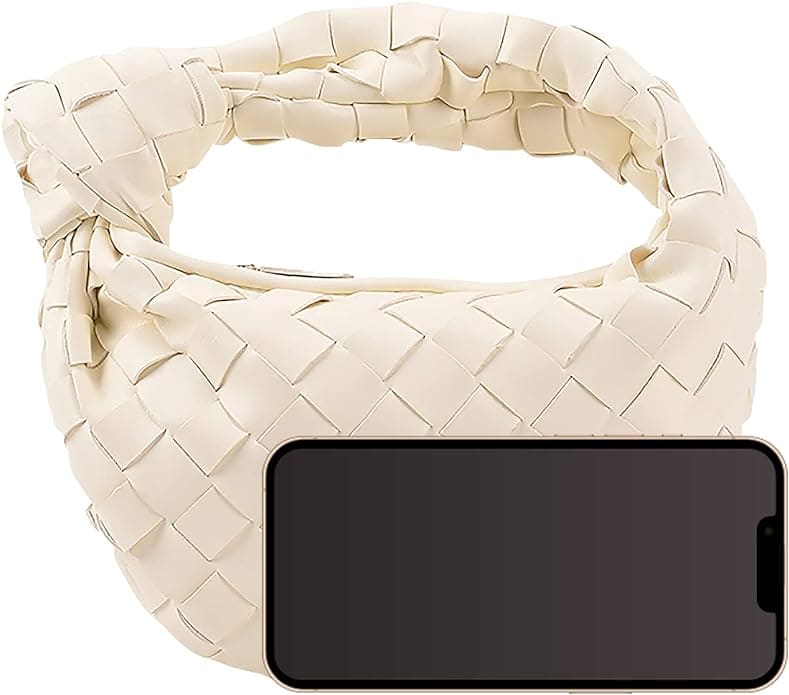 image of a small ivory woven bag with a knot handle and a phone in front