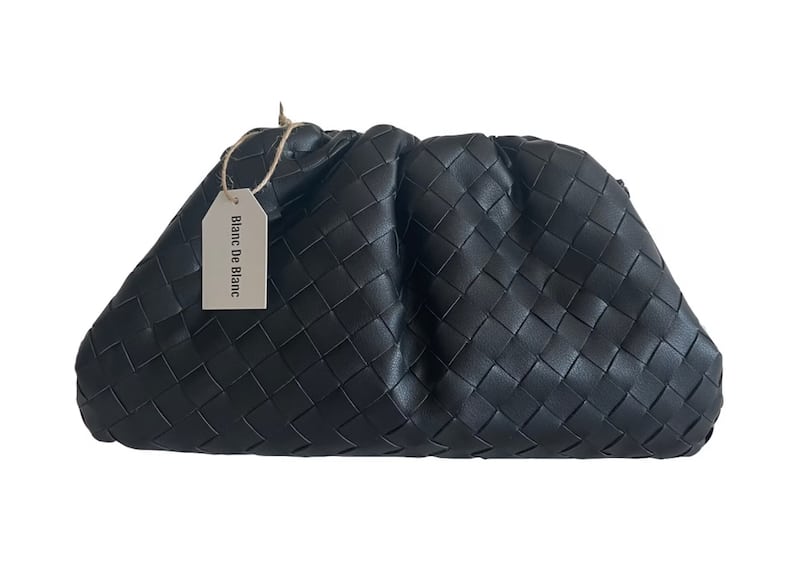 image of a woven pouch bag in black that is a dupe of the Bottega Veneta bag