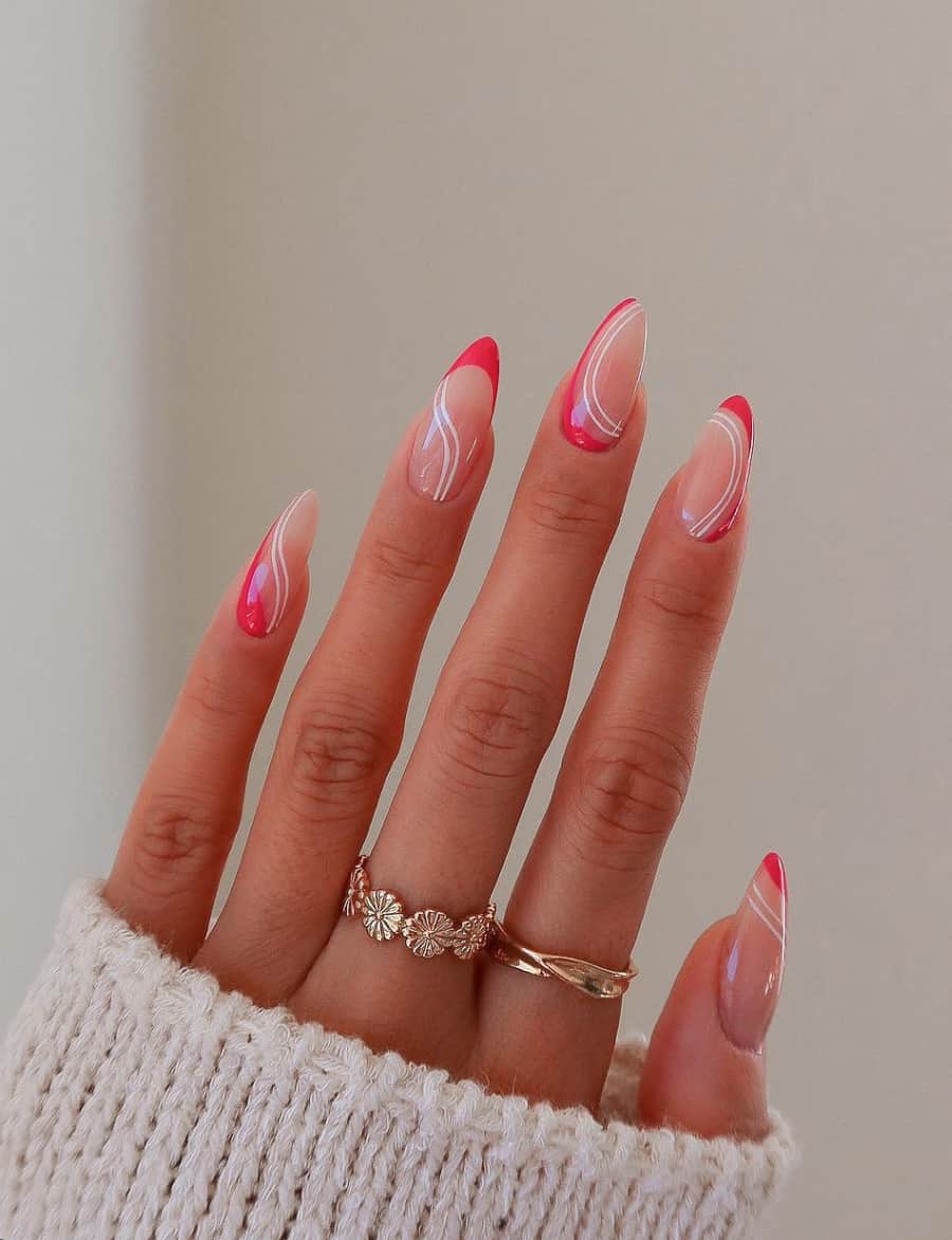 A hand with nude colored almond nails with pink accents and white line details