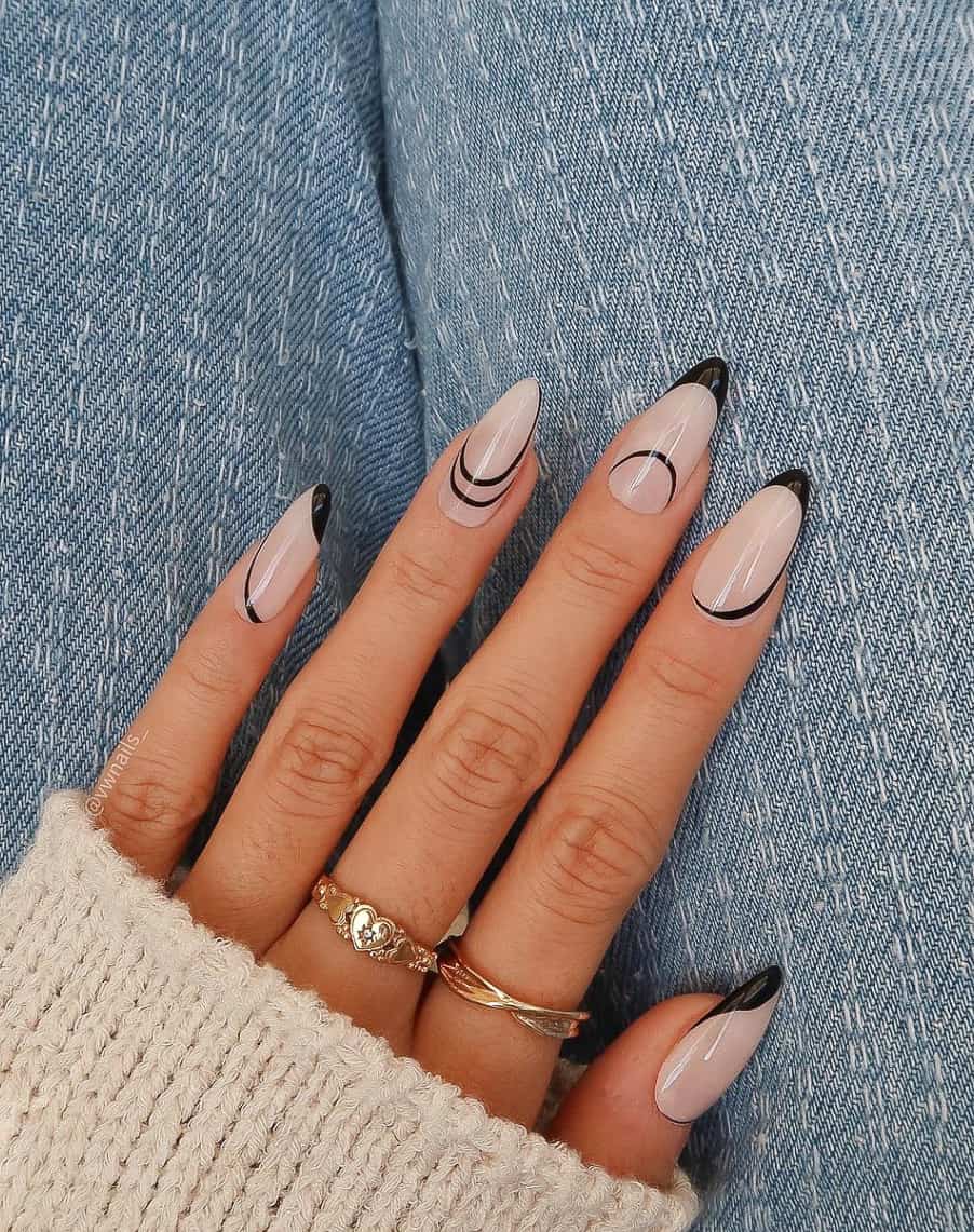 A hand with medium almond nails painted in a translucent white polish and painted with black French tips and line details