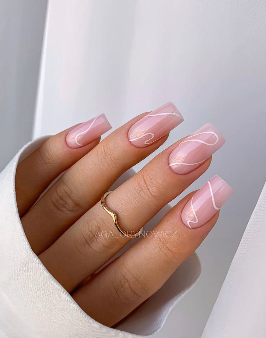 A hand with glossy pastel pink square nails and thin white accent lines