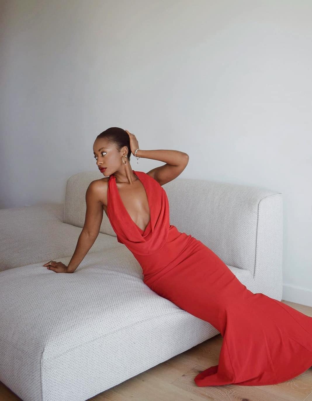 stunning black woman wearing an elegant red gown with a deep v neckline