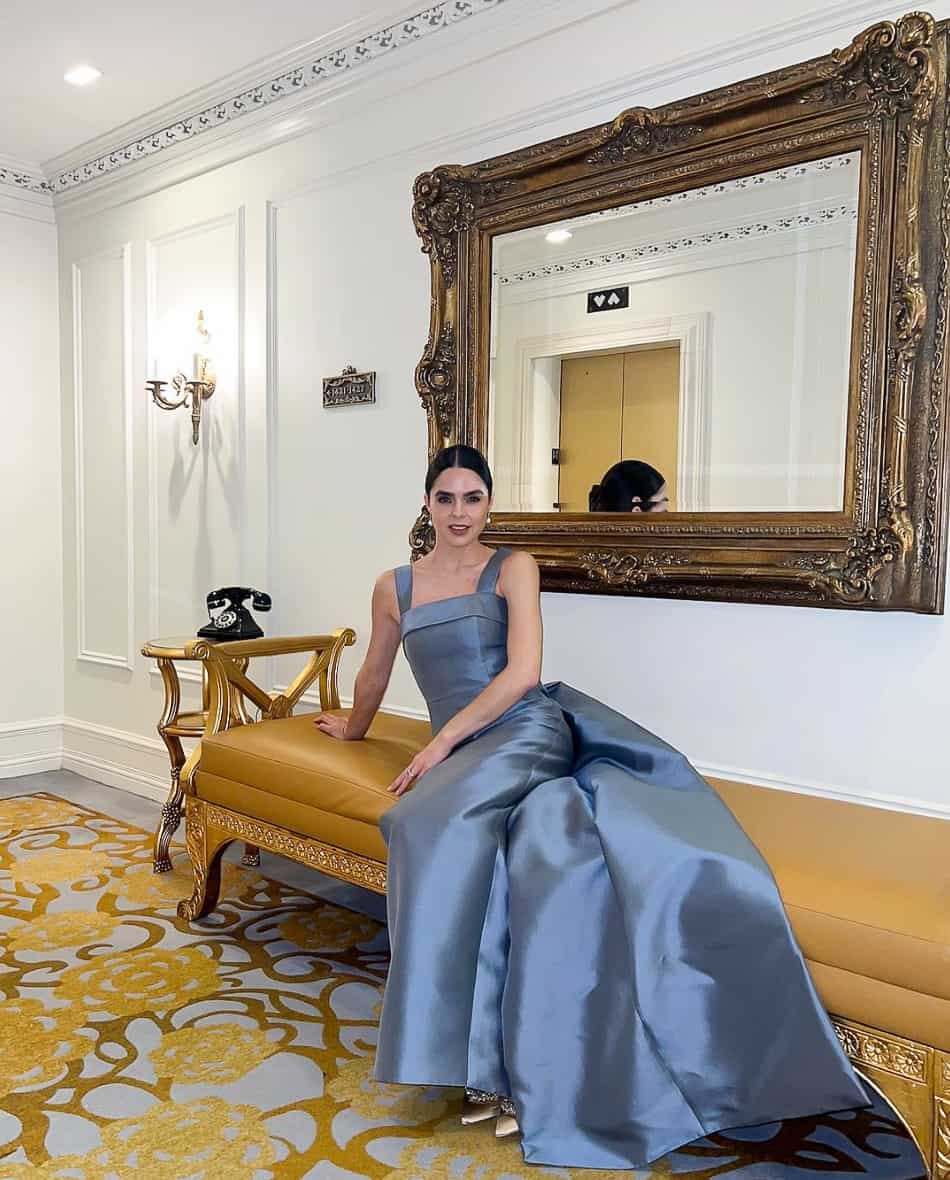 woman wearing a satin blue gown with a long train for a gala event