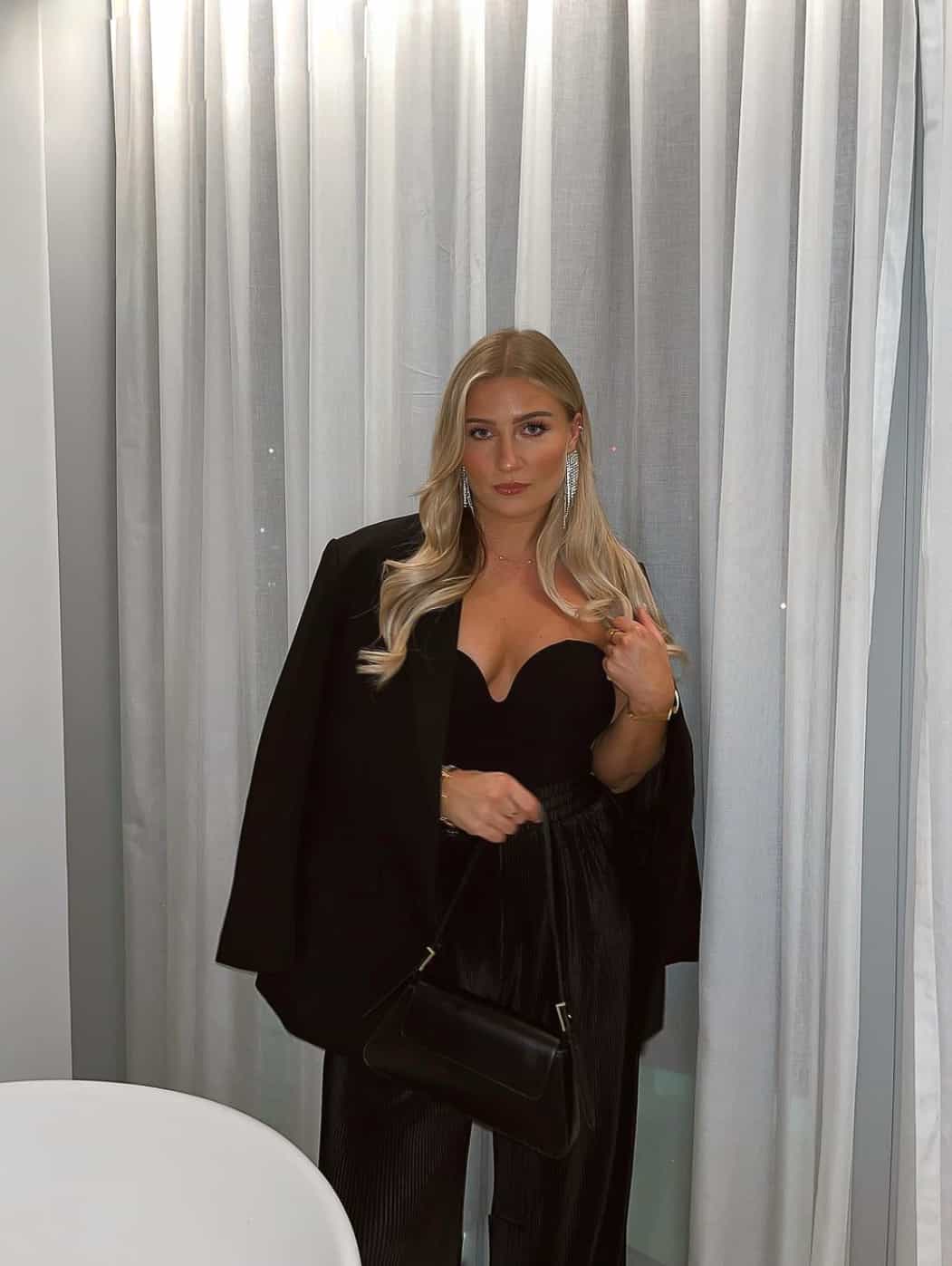 woman wearing a stylish black pantsuit for a fancy gala event