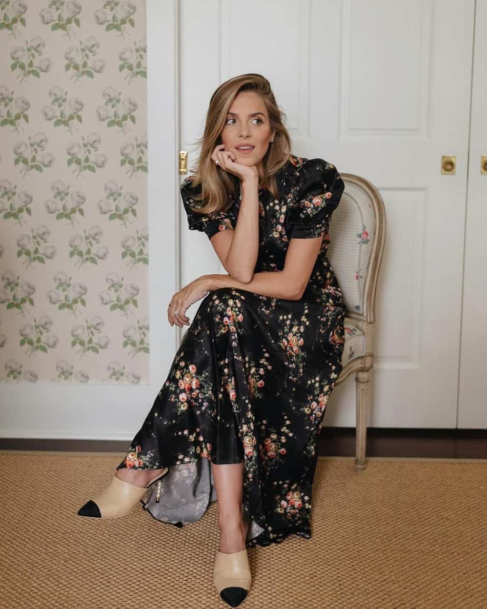 woman sitting on a chair wearing a floral evening gown