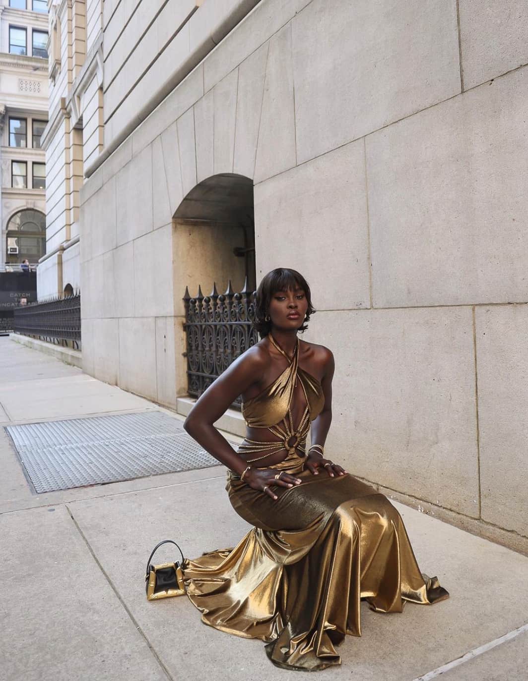 beautiful black woman wearing a gold evening gown