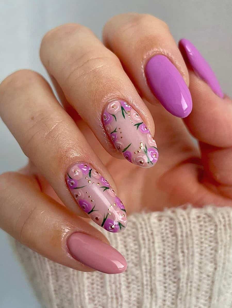 image of a hand with mauve pink nails and floral accents