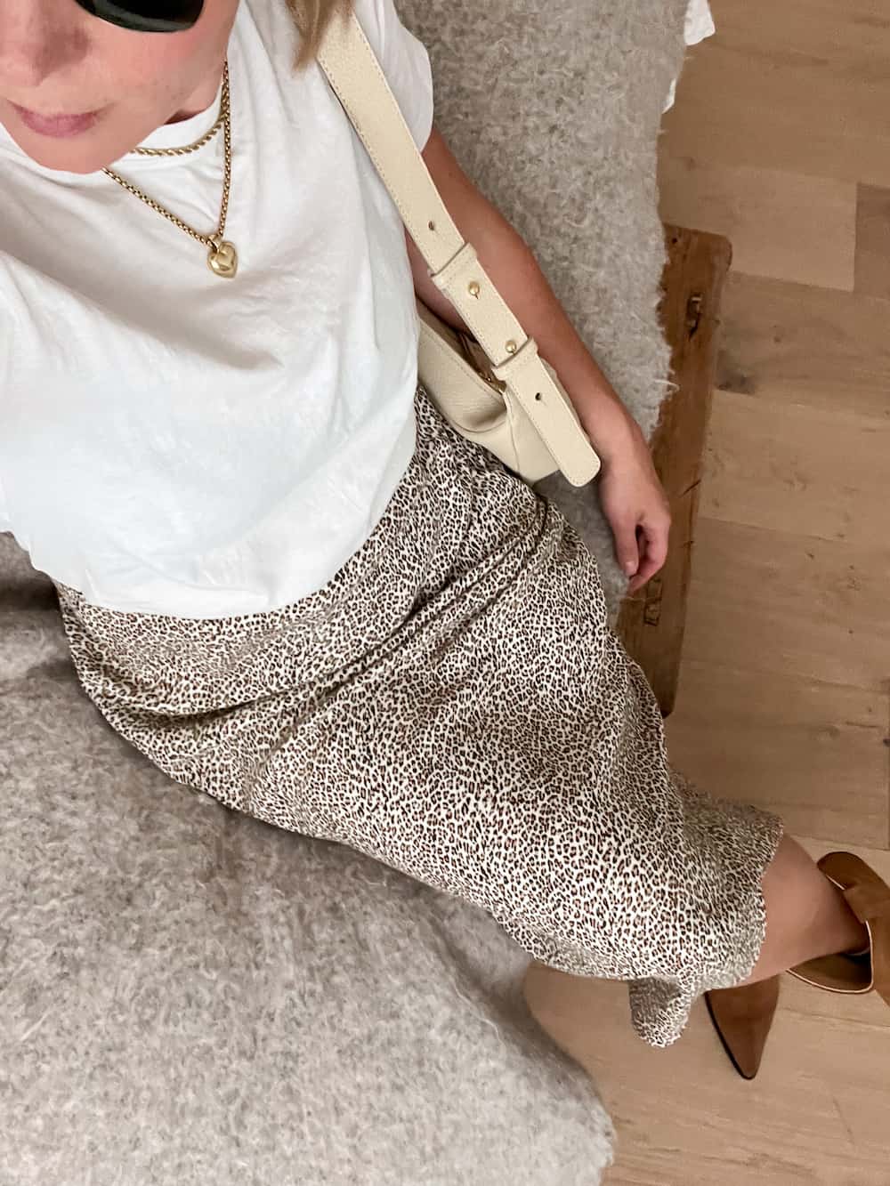 Christal wearing a white t-shirt with the Jenni Kayne leopard slip skirt and brown suede boots