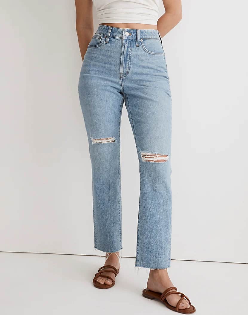 an image of high-rise light-washed jeans with ripped knees and a raw hem from Madewell