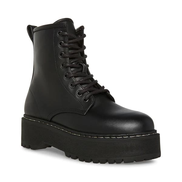 image of a black combat boot with a chunky sole and white stitching above the outsole, with a similar look to Doc Martens