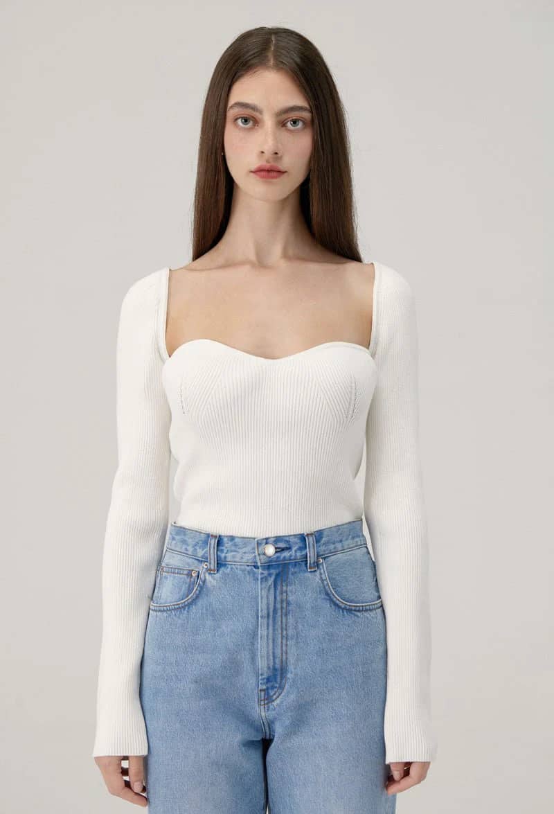 woman wearing a white sweetheart neckline ribbed top that is a Khaite dupe of the Maddy top 