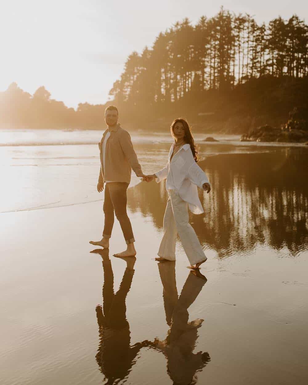 A couple shooting engagement photos wearing neutral and minimal pieces, including a matching white linen set and jeans with a tan button-up
