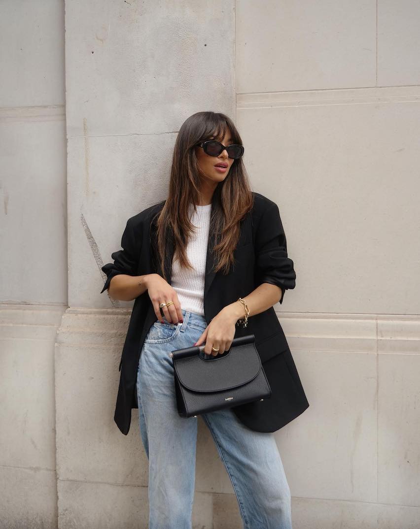 woman wearing an oversized black blazer over a white t-shirt with jeans
