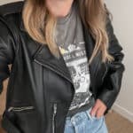 woman wearing a graphic tee with a leather jacket and jeans as part of a capsule wardrobe for fall