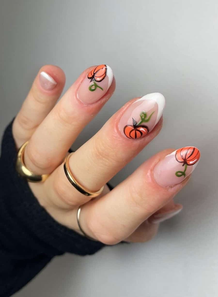 a hand with short almond nails with white French tips and pumpkin nail art
