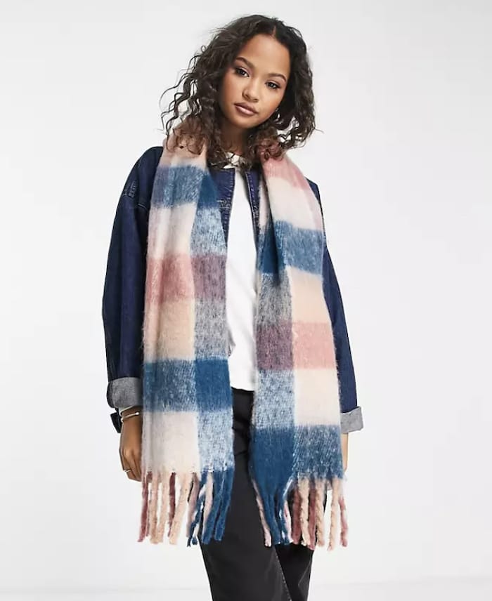A pink, blue, and peach plaid Acne Studios scarf dupe from ASOS with fringed ends