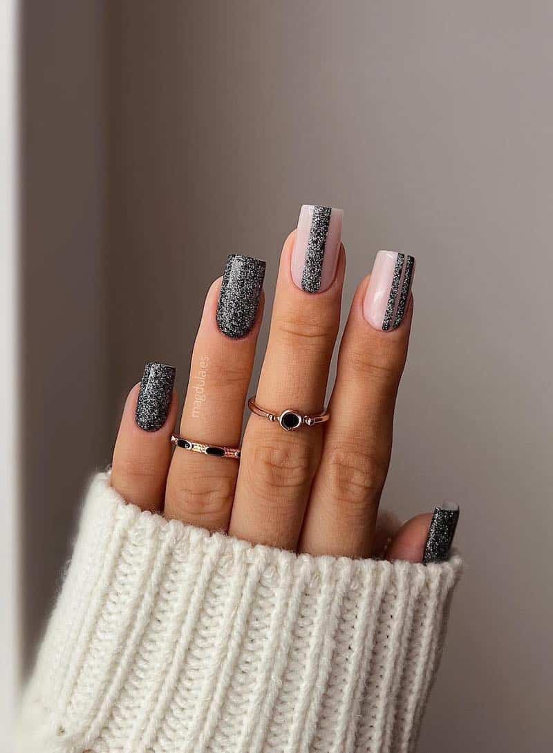 Black square nails with a silver glitter detail.