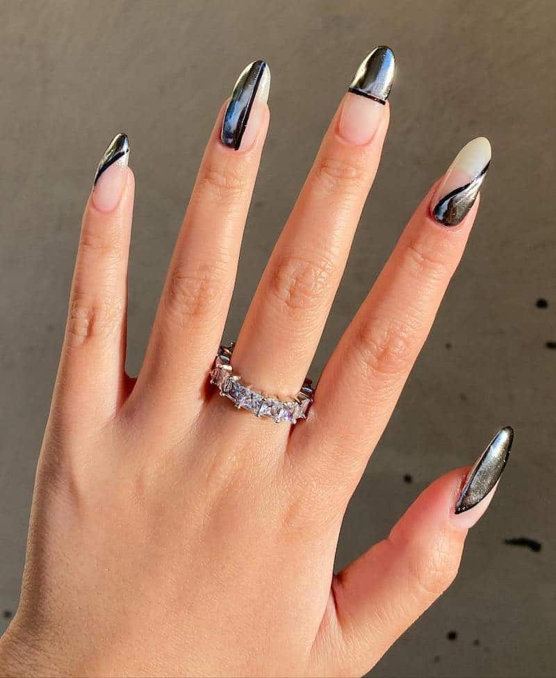 Nude nails with black and silver chrome geometric tip detailing.