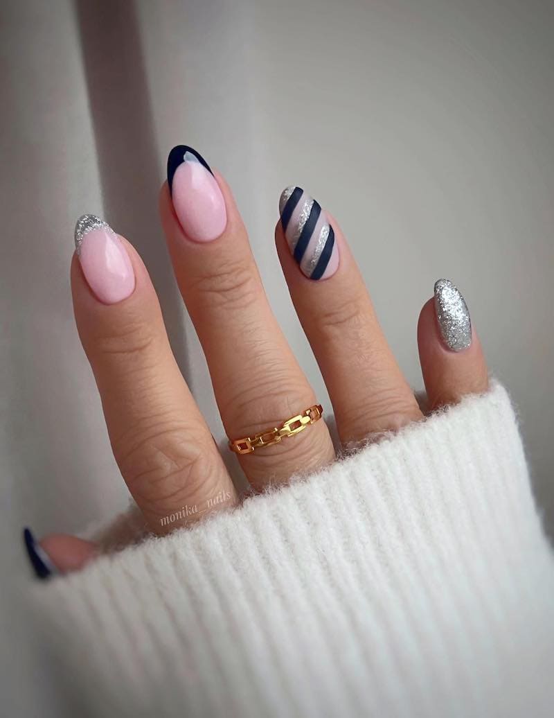 Pink nails with black and silver glitter details.