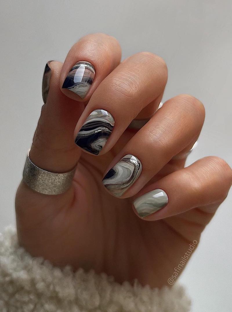 Short and square black, white and silver marbled nails.