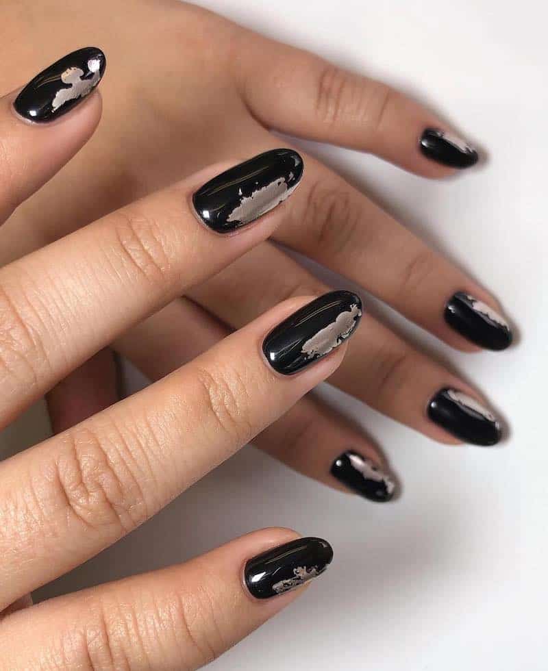 Black glossy nails with silver chrome paint detailing.