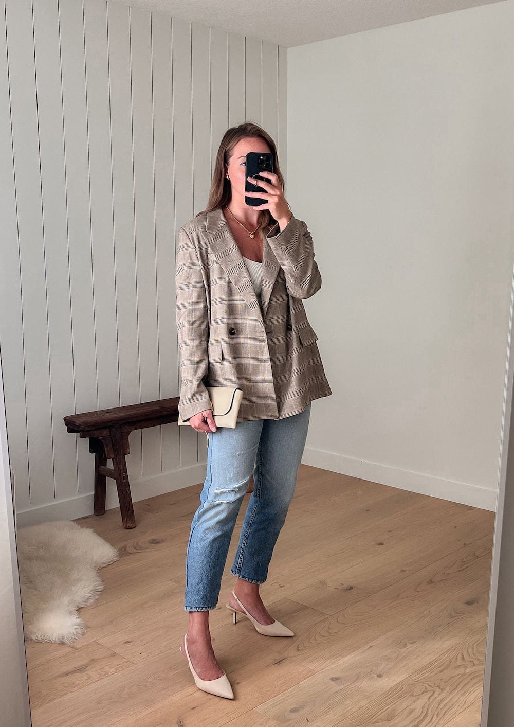 woman wearing a plaid boyfriend blazer with blue jeans and nude slingback heels