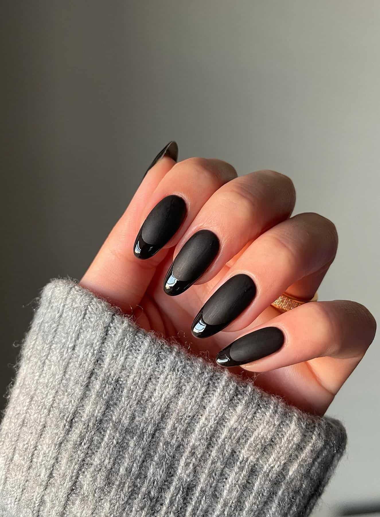 Long matte black almond nails with glossy black French tips