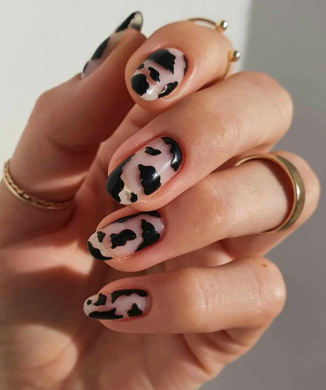 Short nude round nails with black cow print